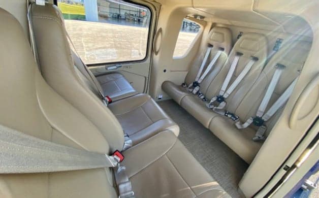 Interior view of the EC135 helicopter cabin with four seats.