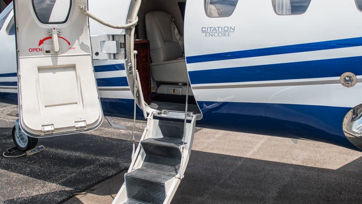 Close up of the open door and steps of a Citation Encore aircraft.