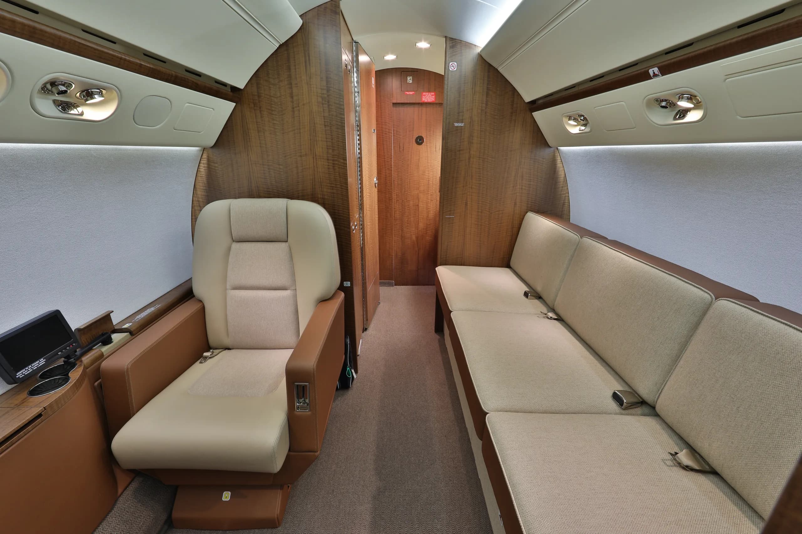 View of the aircraft's interior with a single seat and a couch.