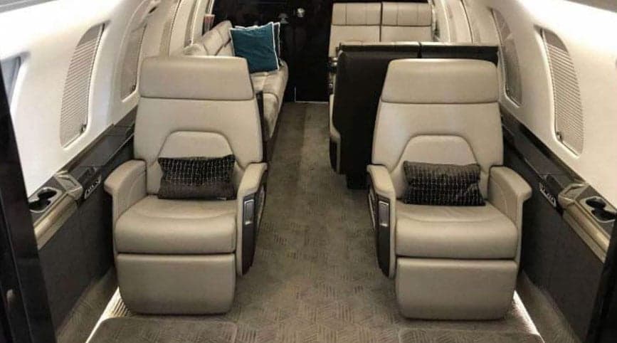 A view of the aircraft cabin showing seats and a divan.