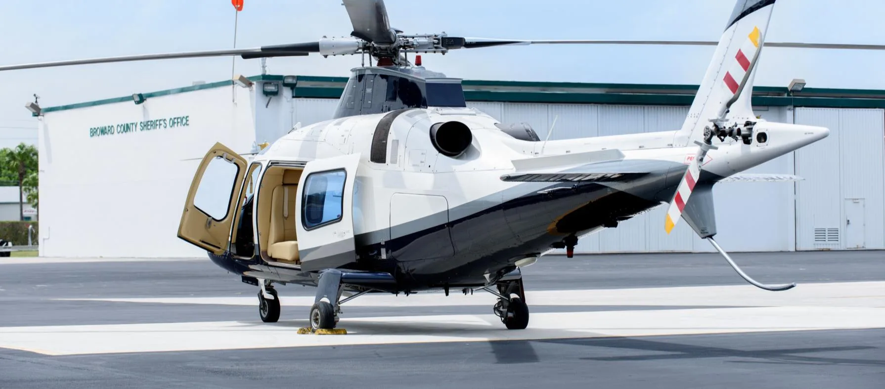 AgustaWestland AW109 helicopter parked in front of the Broward County Sheriff's Office.