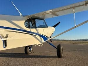 Close up of the CubCrafters XCub N321SY, showing the wing and cockpit.