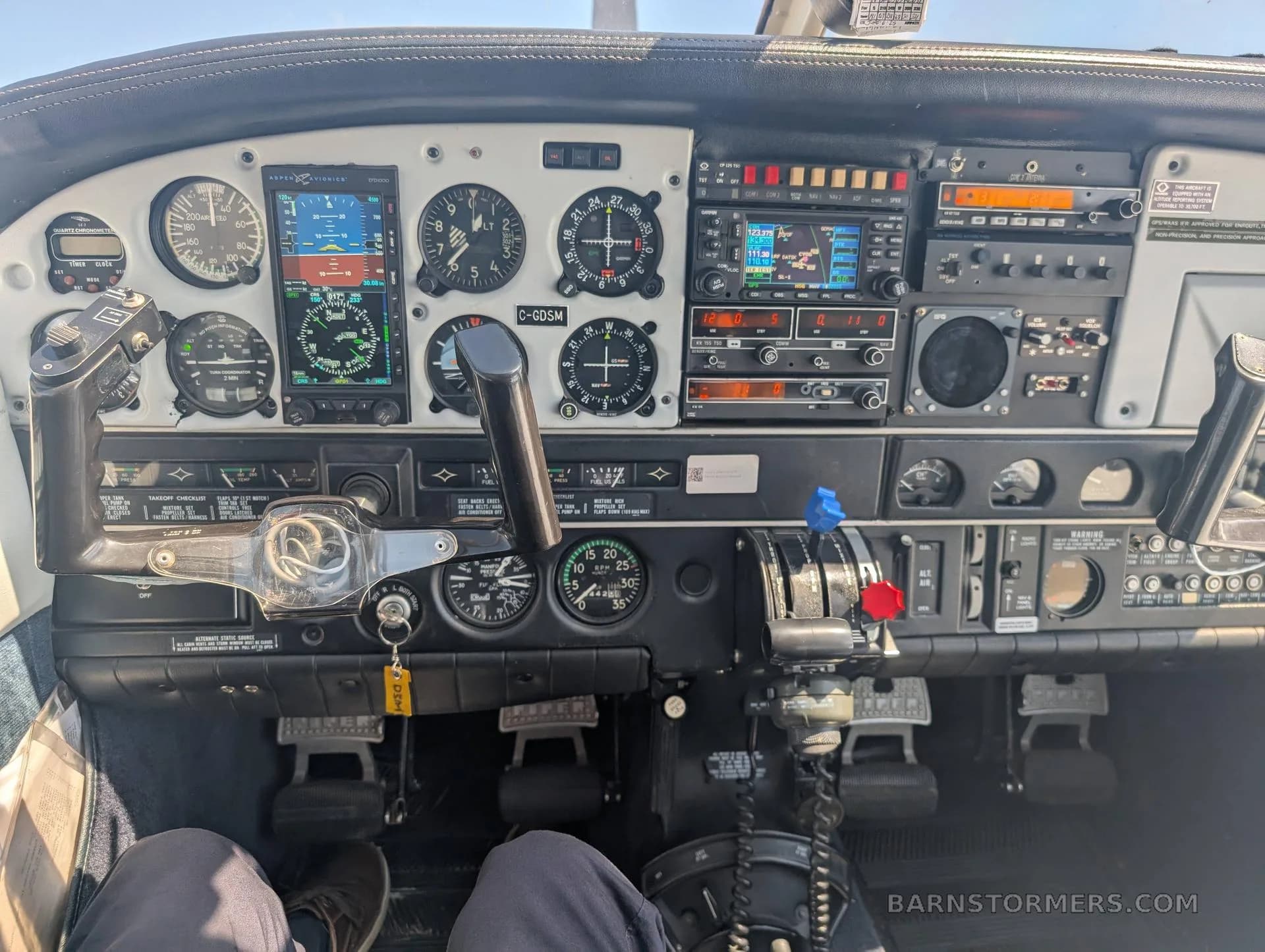 The detailed instrument panel of the Piper Archer 200, featuring various gauges, avionics, and controls.
