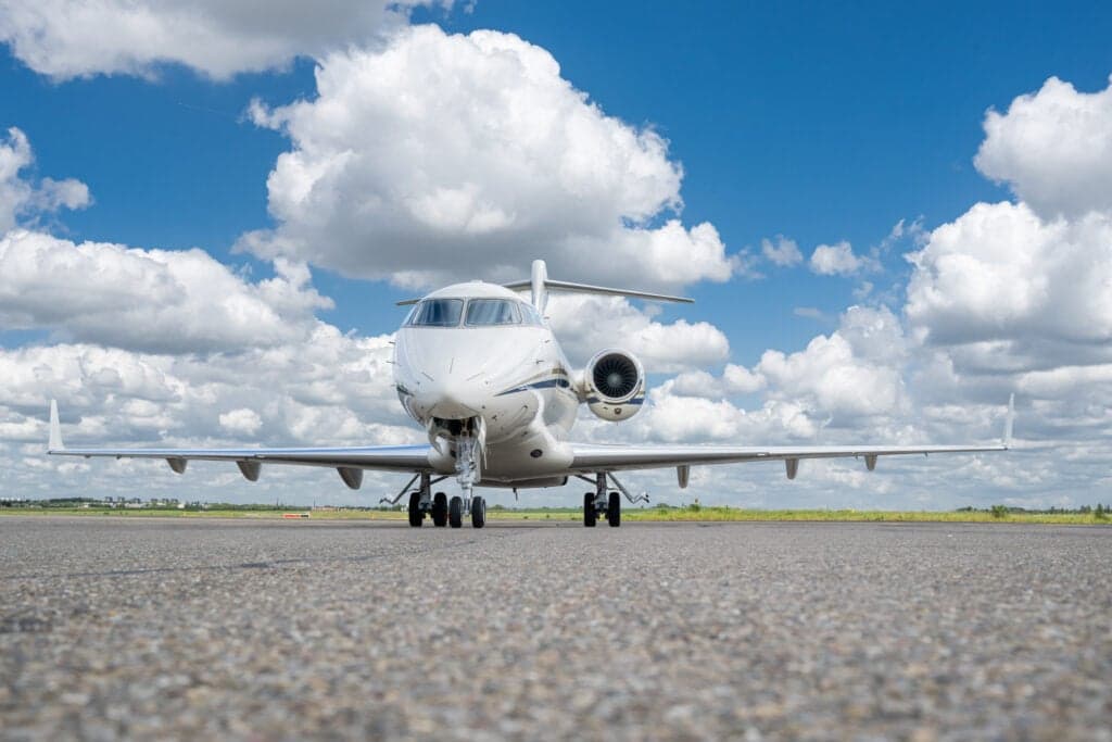 Front view of a Bombardier Challenger 350 aircraft on the tarmac.