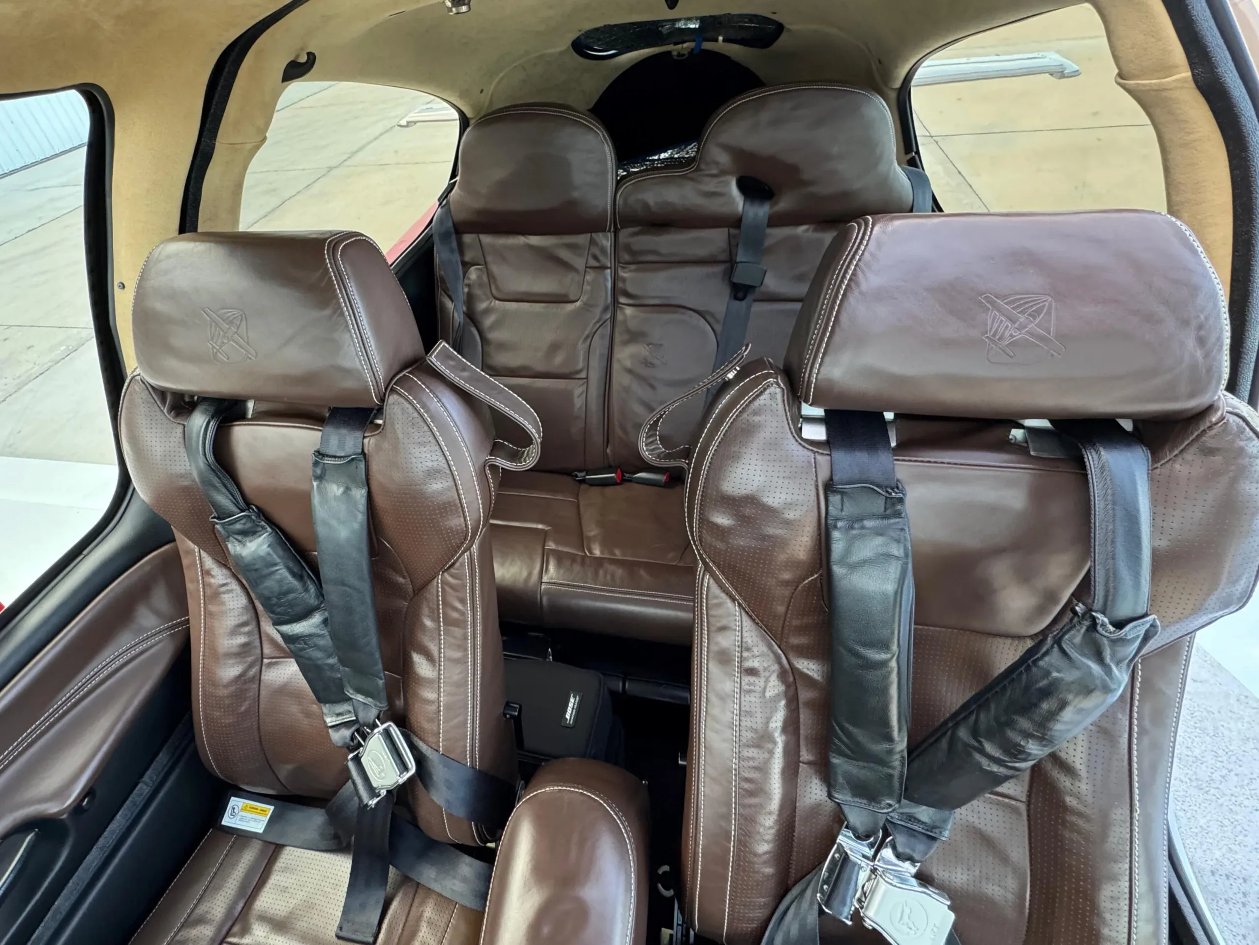The brown leather rear seats of a Cirrus SR22T aircraft cabin.