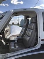 The interior of the aircraft features gray leather seats.