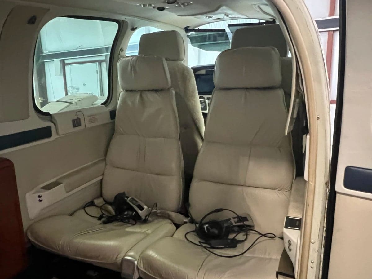 The interior of the aircraft features light-colored leather seats.