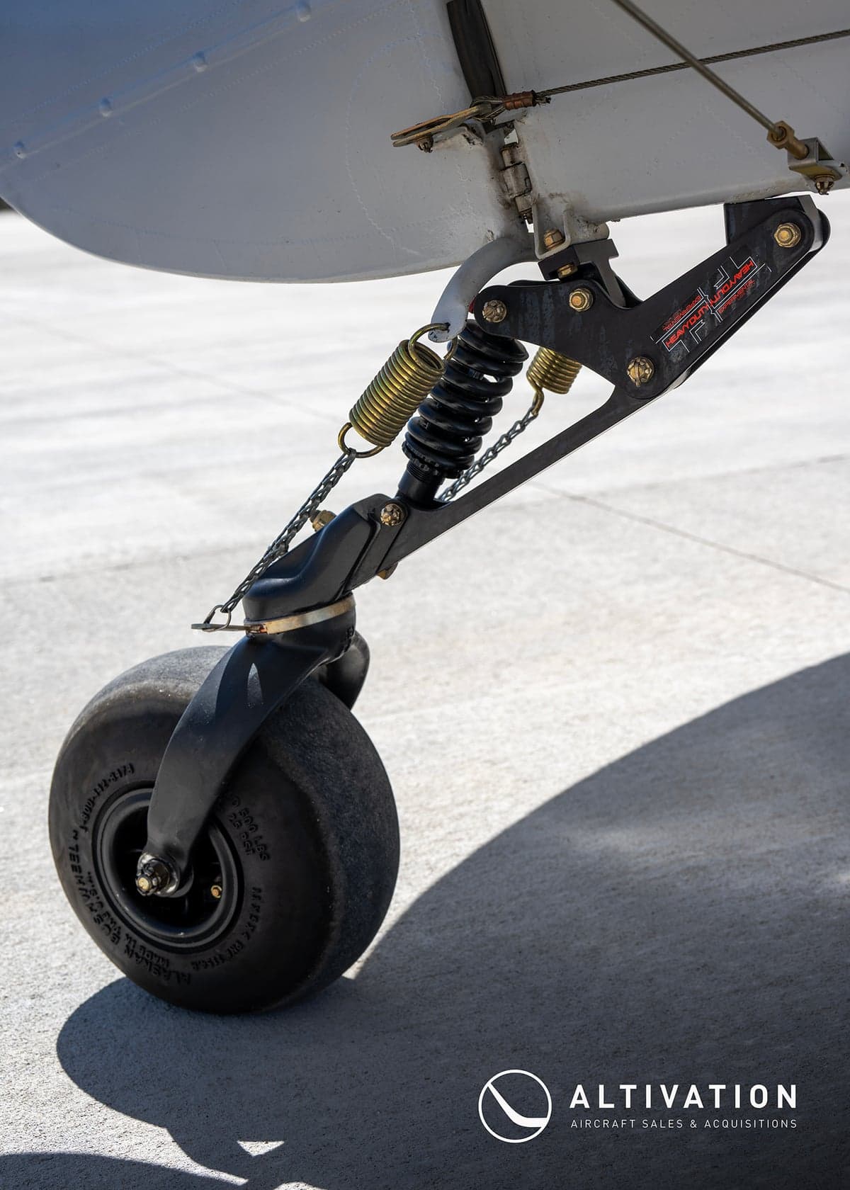 Close-up of the landing gear and tundra tire of the Carbon Cub aircraft.