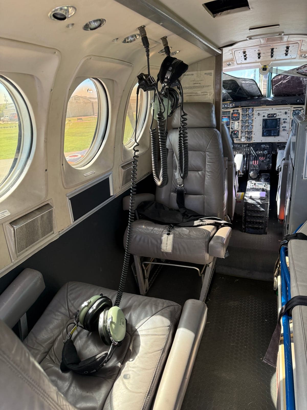 Interior view of the aircraft cabin, showing seating and cockpit access.
