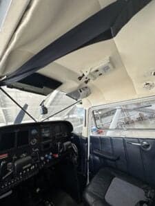 View of the instrument panel and front seats of the aircraft.