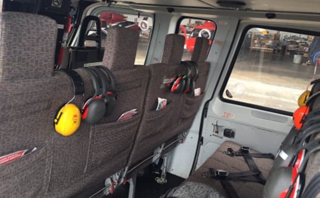 View of the helicopter cockpit with instrument panel and seats.