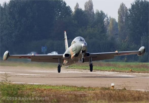 Rear view of camouflaged aircraft I-MBCK in flight.