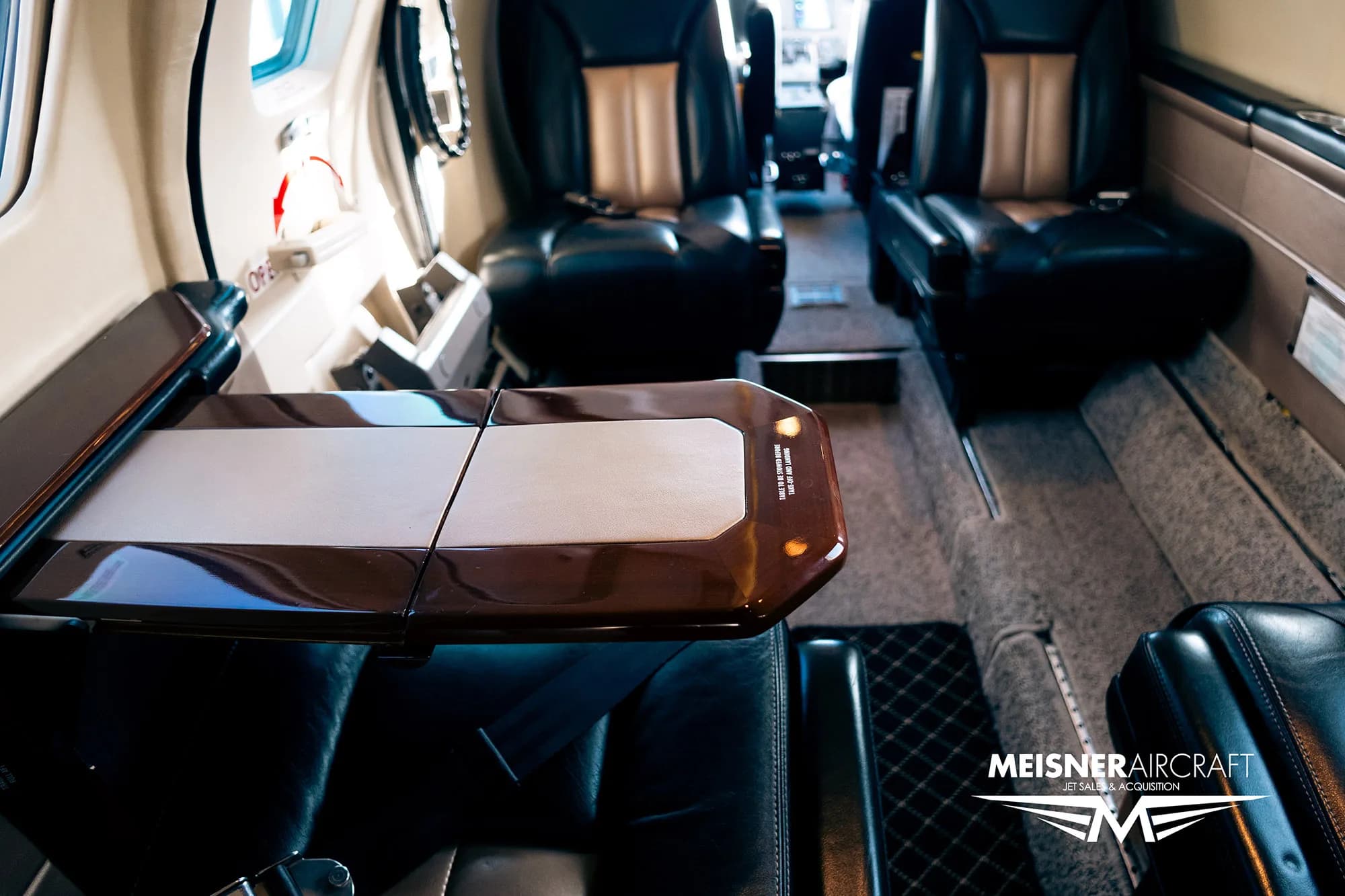 View of the aircraft interior showing a table and seats.