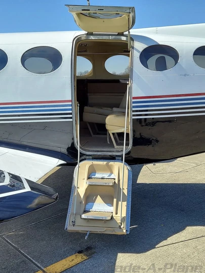 The open door and steps of a Cessna 414 aircraft.