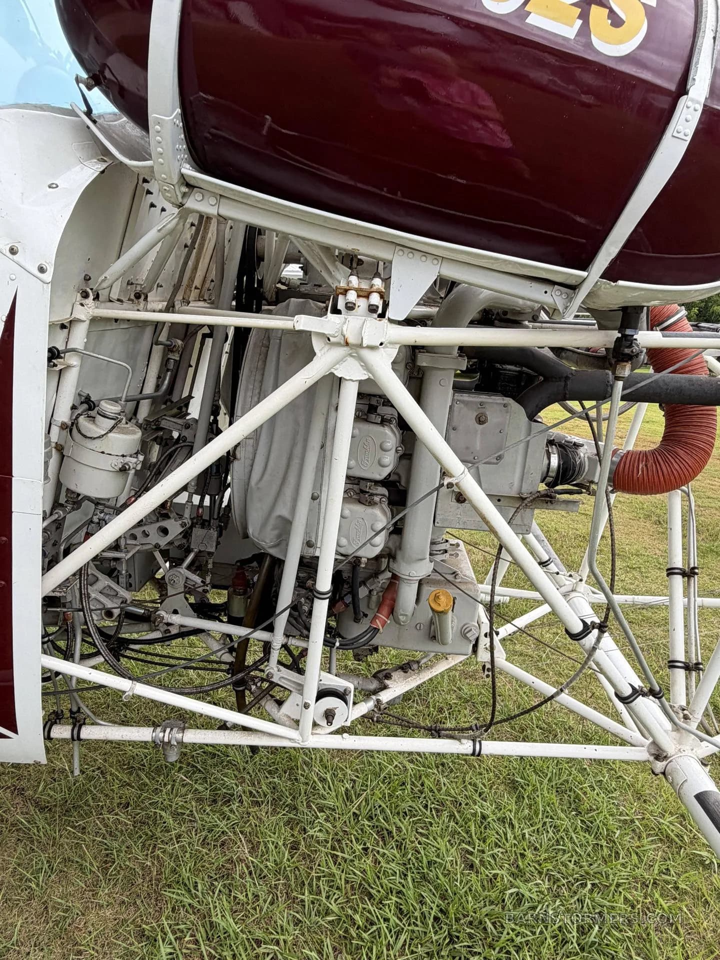 A detailed view of the exposed engine and structural frame of the helicopter.