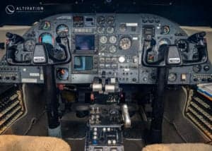 The interior of the aircraft features tan leather seats and fold-out tables.