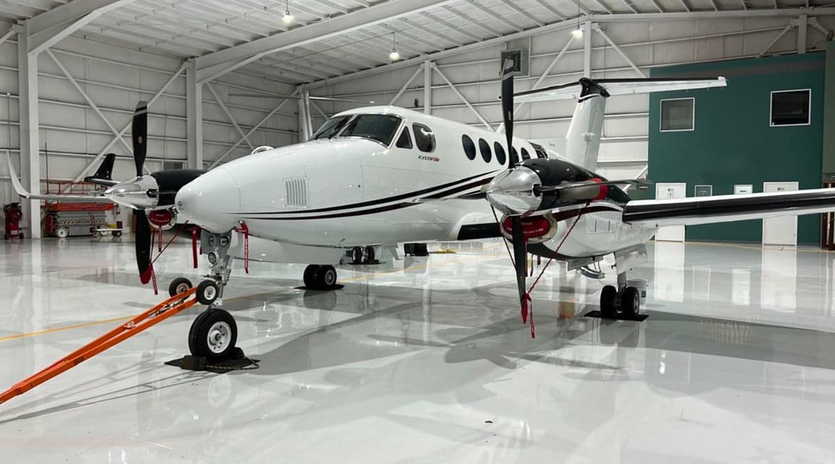 Front view of a King Air 250 in a hangar.