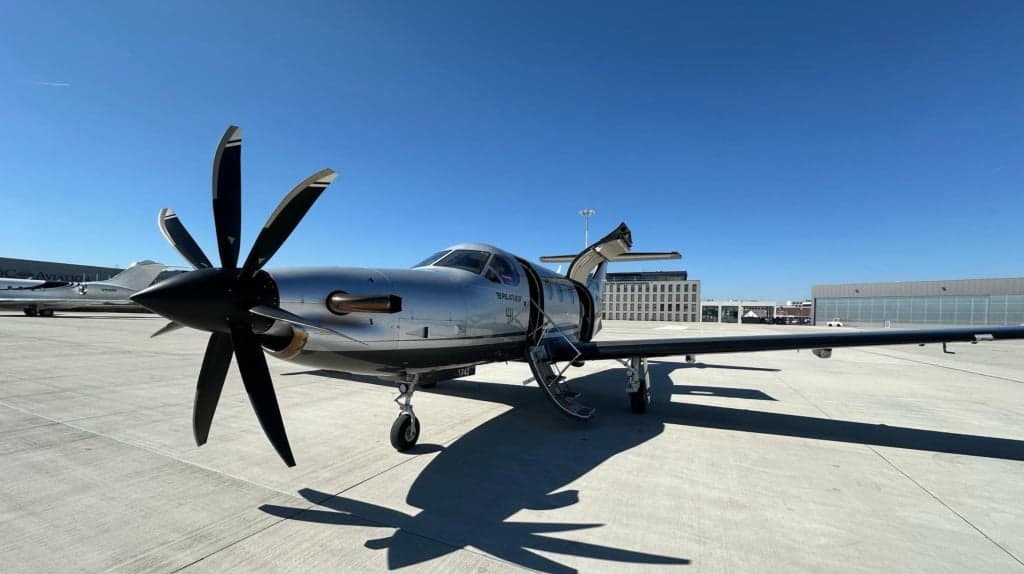Pilatus PC-12 aircraft D-FCYW on the tarmac with the door open.