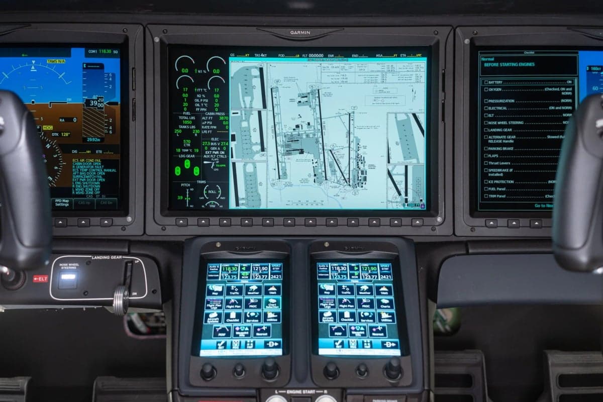 Close-up of the display screens in the HondaJet cockpit showing flight information.
