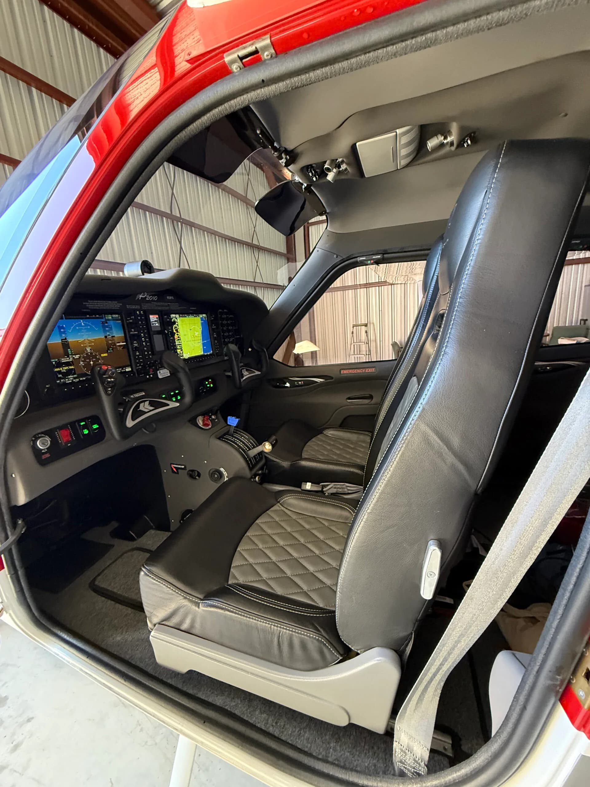 View of the aircraft's cockpit and front seats with diamond-patterned upholstery.