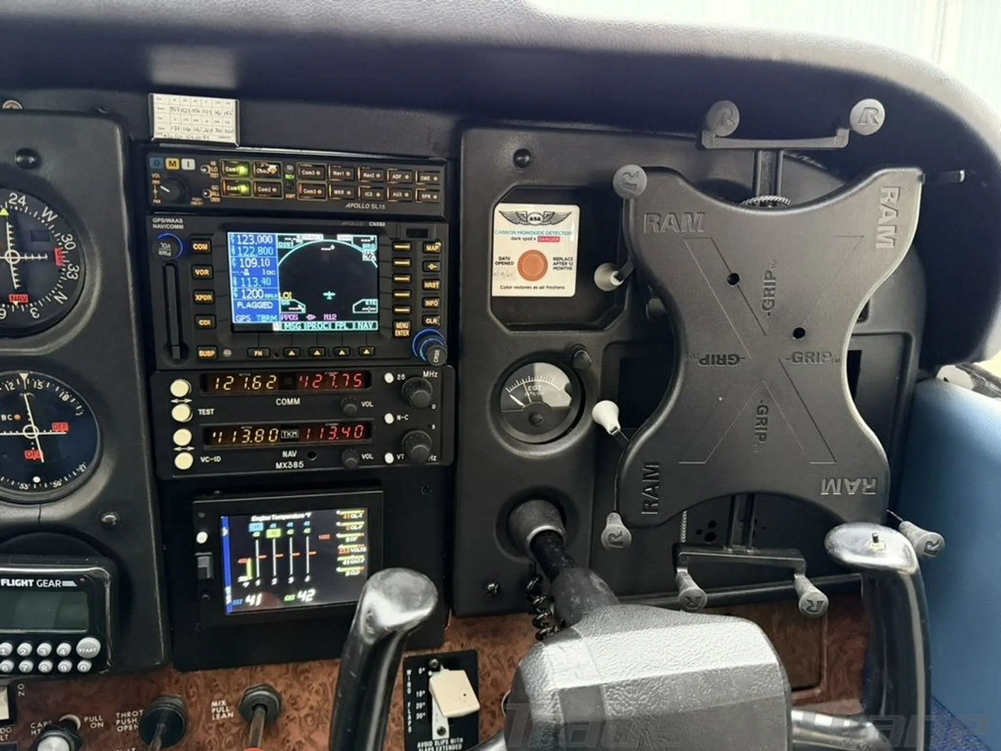 A close-up view of the right side of the cockpit instrument panel, showing avionics and a RAM mount.