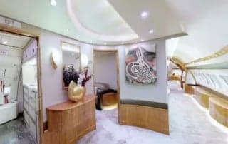 A view of the aircraft's interior, featuring a hallway and a painting.