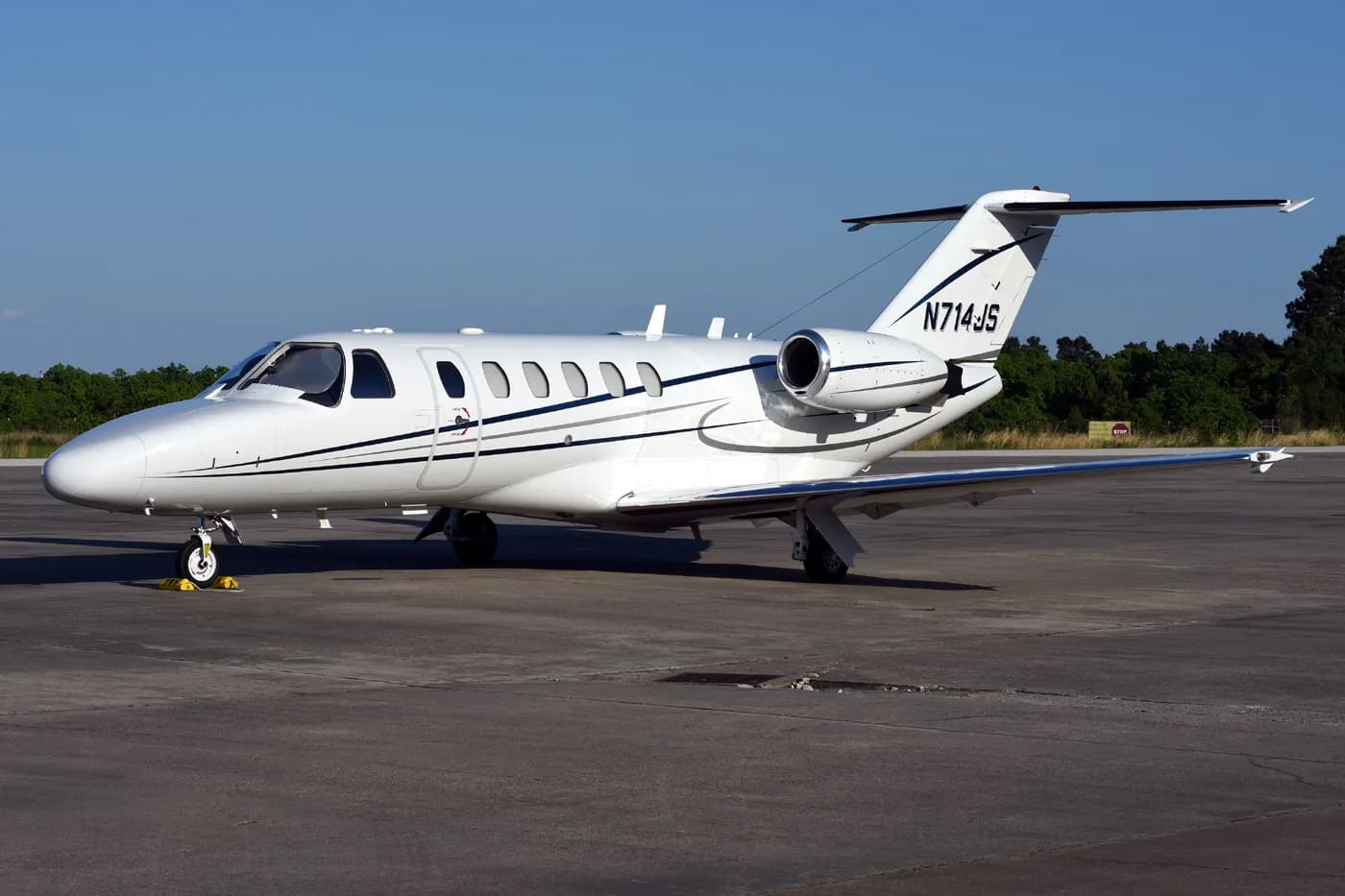 A white Cessna Citation CJ1+ aircraft with registration N714JS parked on the tarmac.