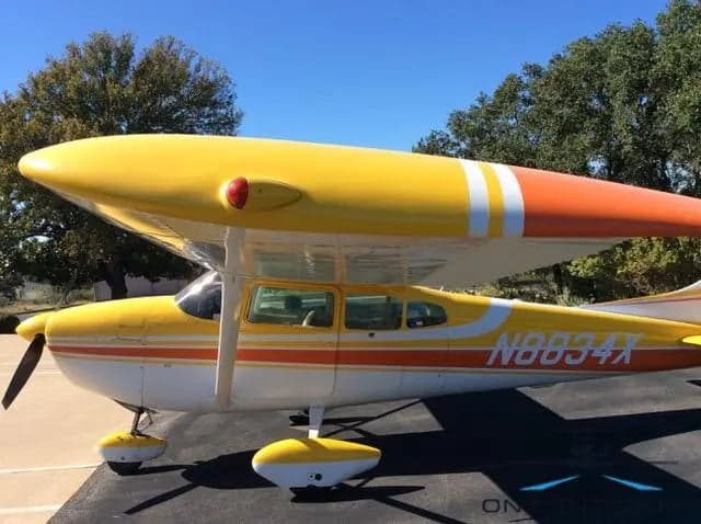 Close-up side view of N8834X Cessna 172 Skyhawk showing the wing and fuselage.
