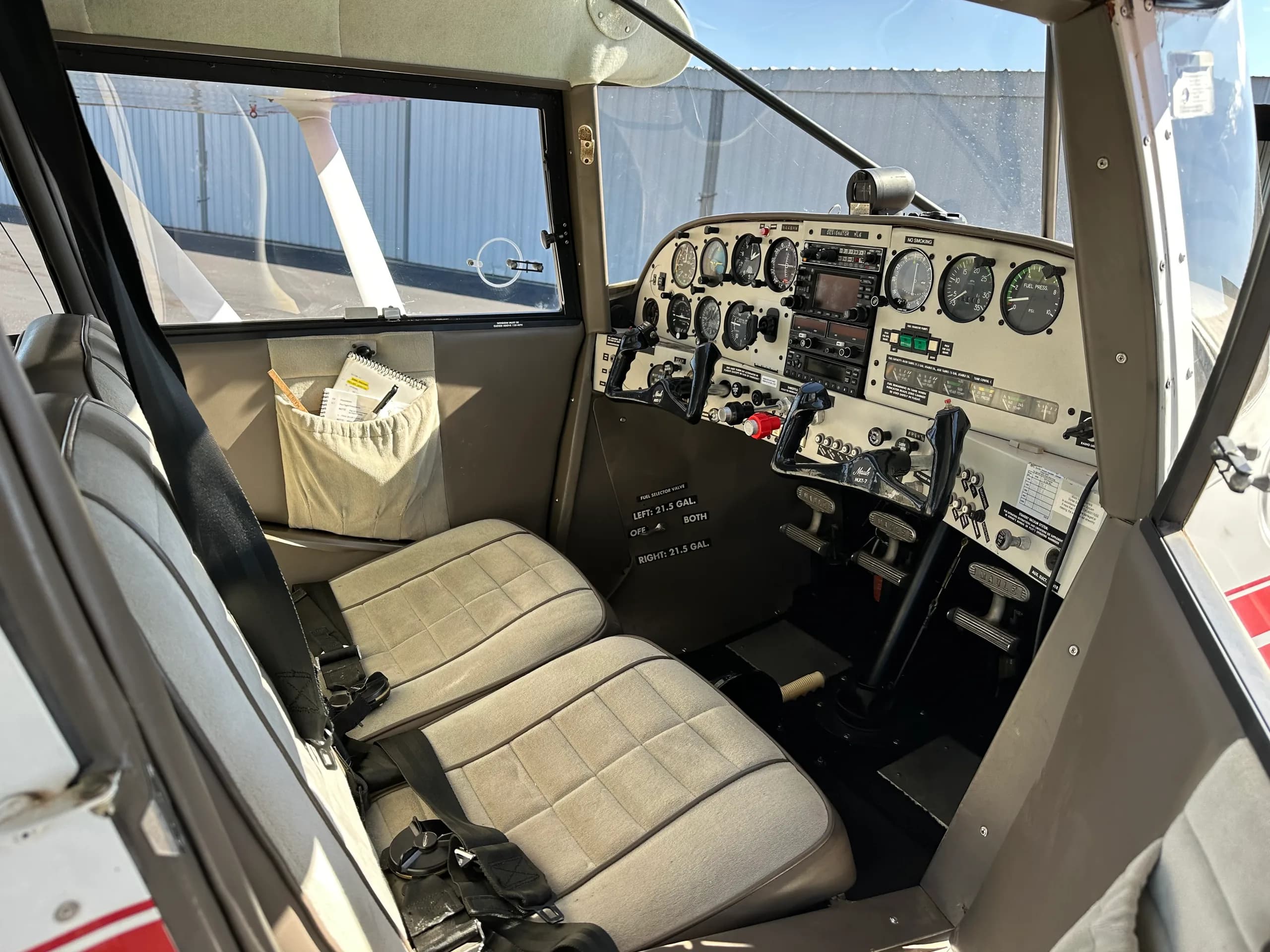 View of the cockpit with seats and instrument panel.