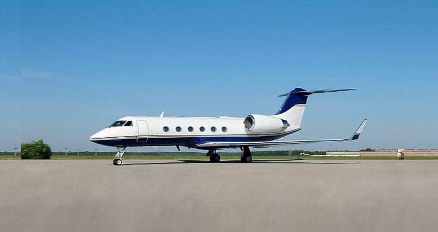 A Gulfstream business jet is parked on the tarmac.