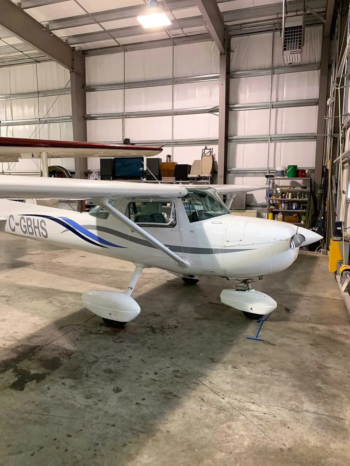 Cessna 172 Skyhawk in a hangar, side view.