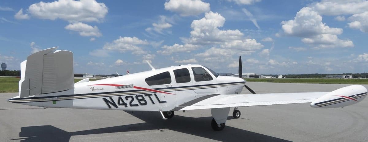 Side view of the Beechcraft Bonanza N428TL showing the tail and registration.