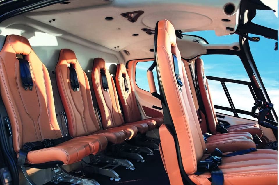 Interior view of the helicopter cabin with tan leather seats.