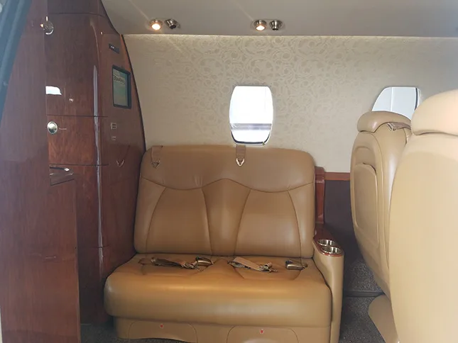 Interior view of the aircraft showing the cabin seats and a window.