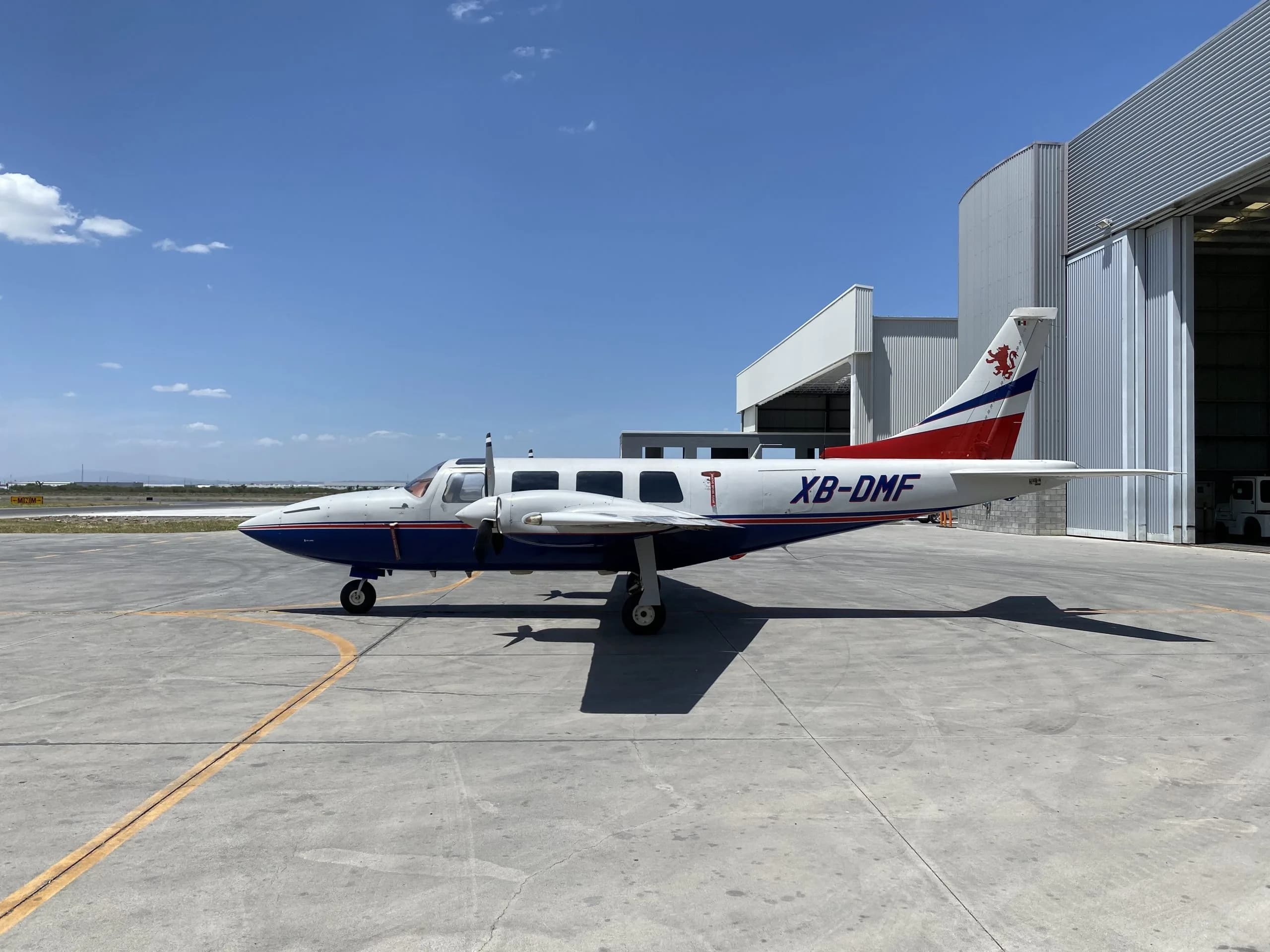 Side view of the XB-DMF aircraft parked on the tarmac.