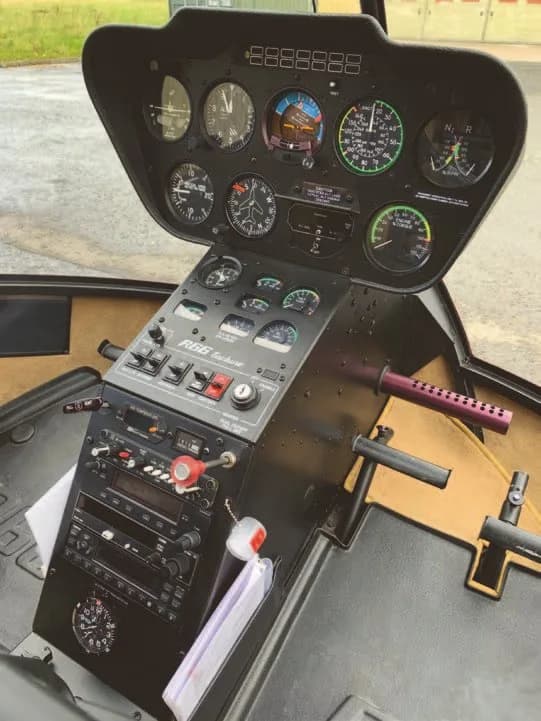 The instrument panel of a Robinson R66 Turbine helicopter with various gauges and controls.