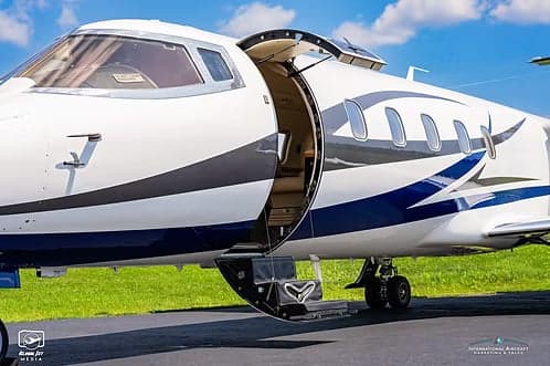 A Learjet 45XR, registration N156DH, with the entry door open.