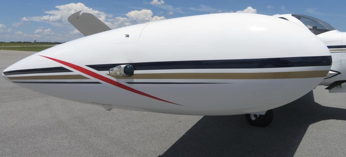 Close-up of the Beechcraft Bonanza N428TL wingtip fuel tank and paint details.