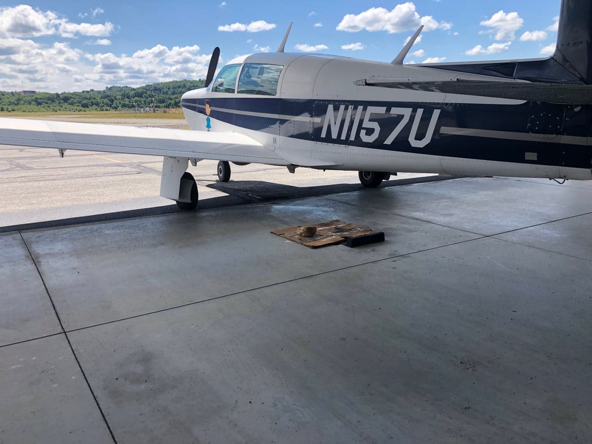 Side view of the N1157U aircraft on the tarmac.