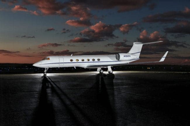 Gulfstream G550 aircraft N280PH parked on the tarmac at dusk.