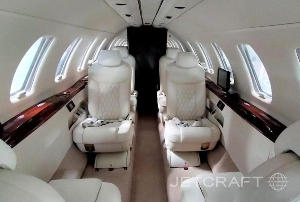 View of the interior cabin with white leather seats.