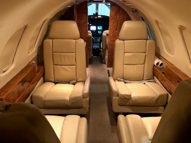View of the Cessna Citation cabin with tan leather seats.