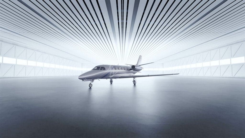 A light jet parked inside a hangar.