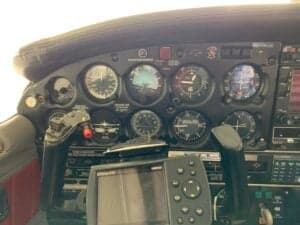 Close-up of the aircraft instrument panel gauges and controls.