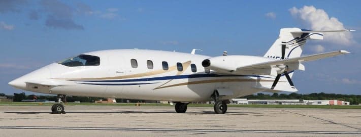 A Piaggio Avanti EVO on the tarmac with a white and gold paint scheme.
