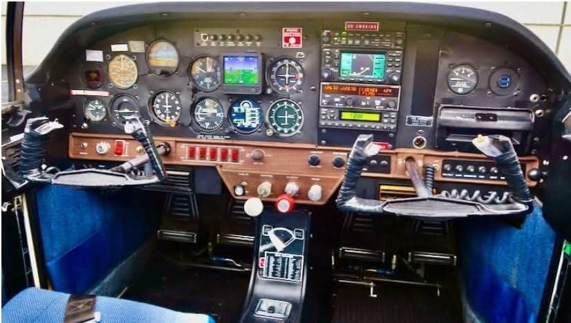 The cockpit of the aircraft features a full instrument panel and control sticks.