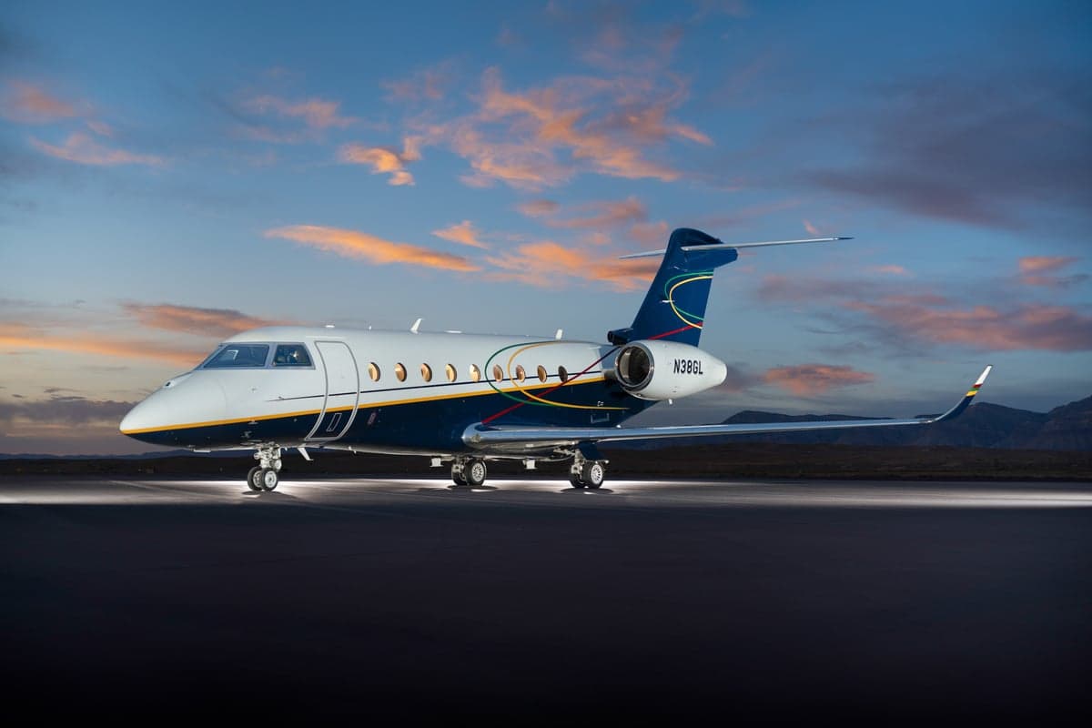 Gulfstream jet N386GL parked on a runway at dusk.