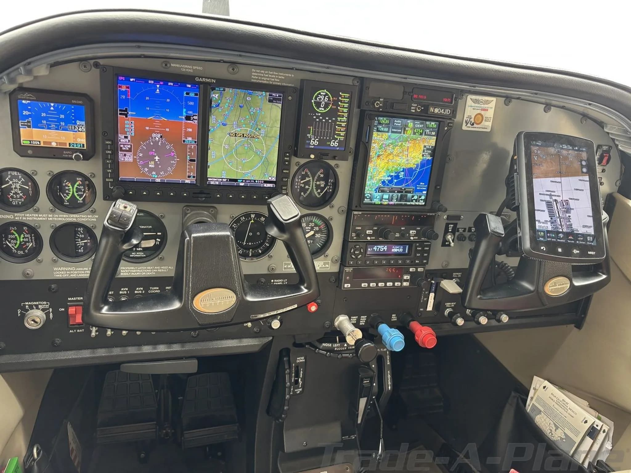 The cockpit of a Cessna 182 Skylane TC, featuring a modern glass panel with multiple Garmin displays and traditional analog gauges.