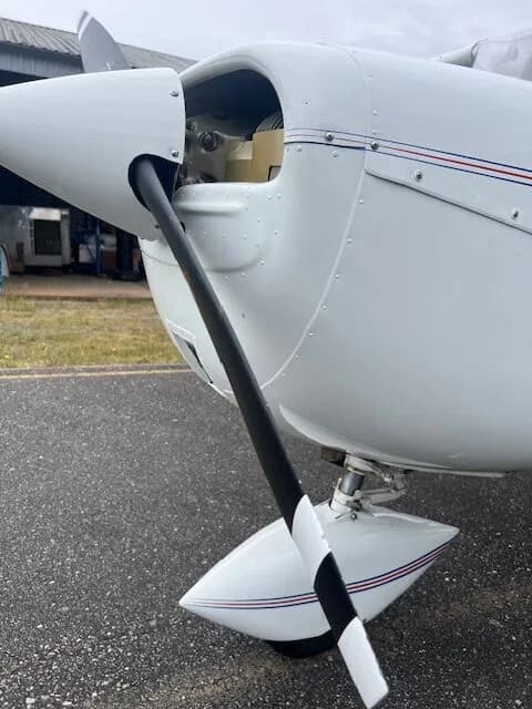 Close-up of the propeller and engine cowling of the C-FZCE Cessna aircraft.