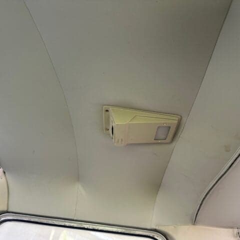 A view of the interior ceiling of the aircraft cabin.
